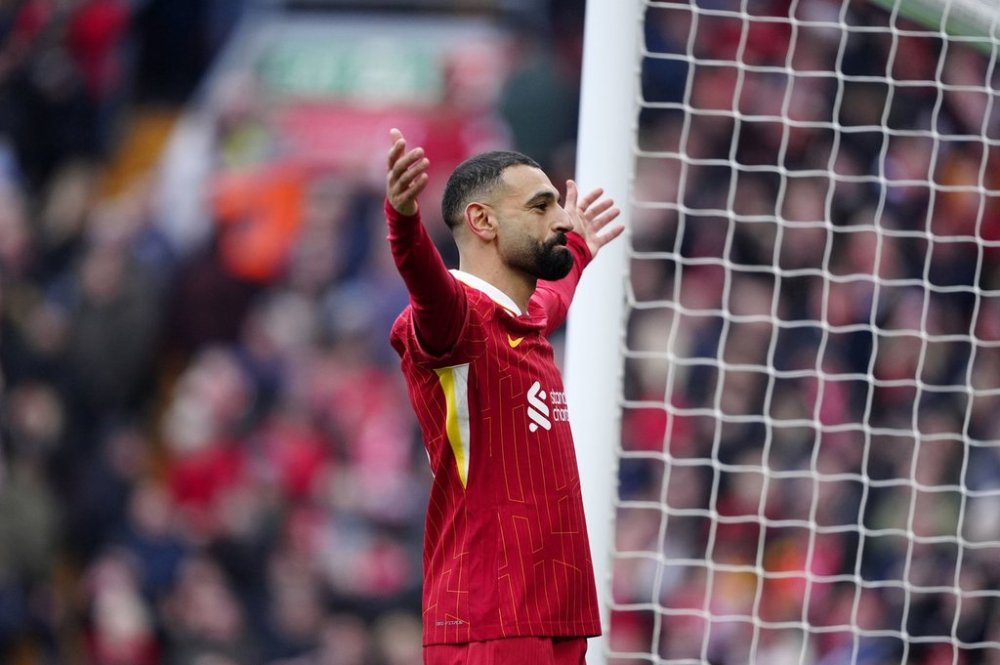 Liverpool's Mohamed Salah celebrates after scoring his side' second goal during the English Premier League soccer match between Liverpool and Wolverhampton Wanderers at Anfield Stadium in Liverpool, Sunday, Feb. 16, 2025. (Peter Byrne/PA via AP)