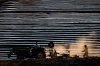 A man drives a tractor as another follows behind while laying down rows of plastic in preparation to grow cantaloupes at a farm in Osoyoos, B.C., on Sunday May 13, 2018. THE CANADIAN PRESS/Darryl Dyck