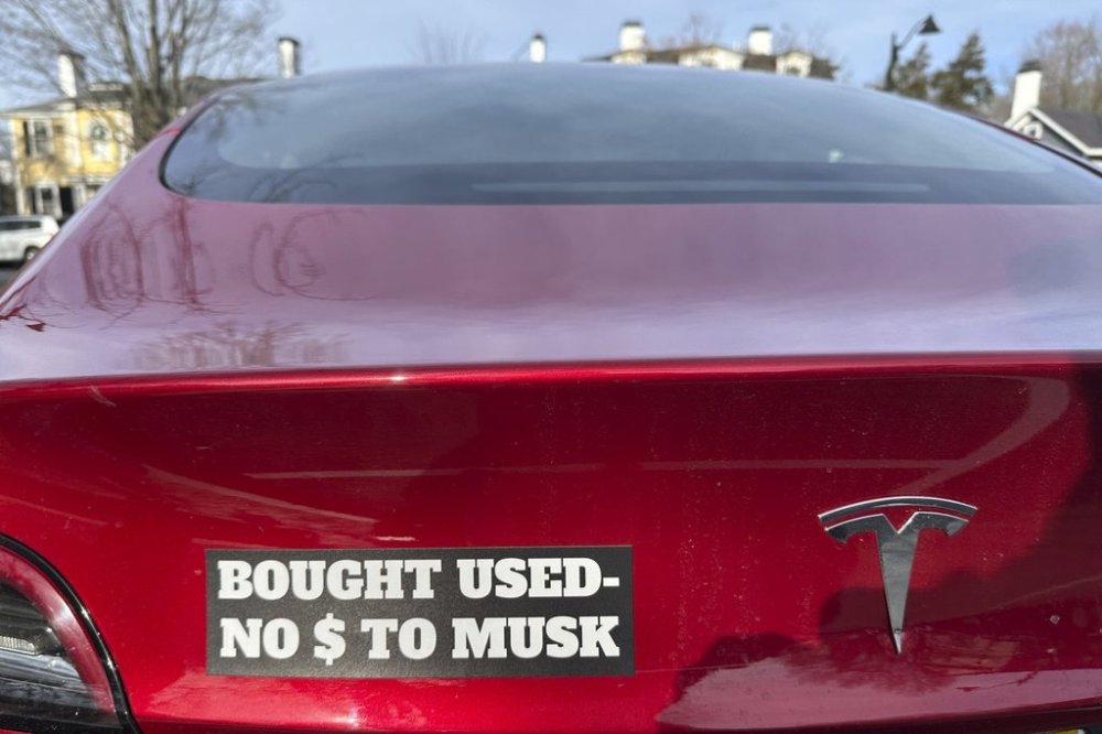 A Tesla with a sticker referring to the car's purchase is shown in Concord, Mass., Dec. 15, 2024. THE CANADIAN PRESS/AP-Peter Morgan