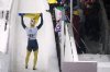 FILE - Valdyslav Heraskevych, of Ukraine, waves a flag as he finishes his second run during the World Cup skeleton competition in Lake Placid, N.Y., Thursday, March 21, 2024. (AP Photo/Seth Wenig, File)