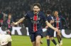 PSG's Khvicha Kvaratskhelia celebrates after scoring his sides second goal during the French League One soccer match between Paris Saint-Germain and Monaco at Parc des Princes stadium in Paris, Friday, Feb. 7, 2025. (AP Photo/Michel Euler)