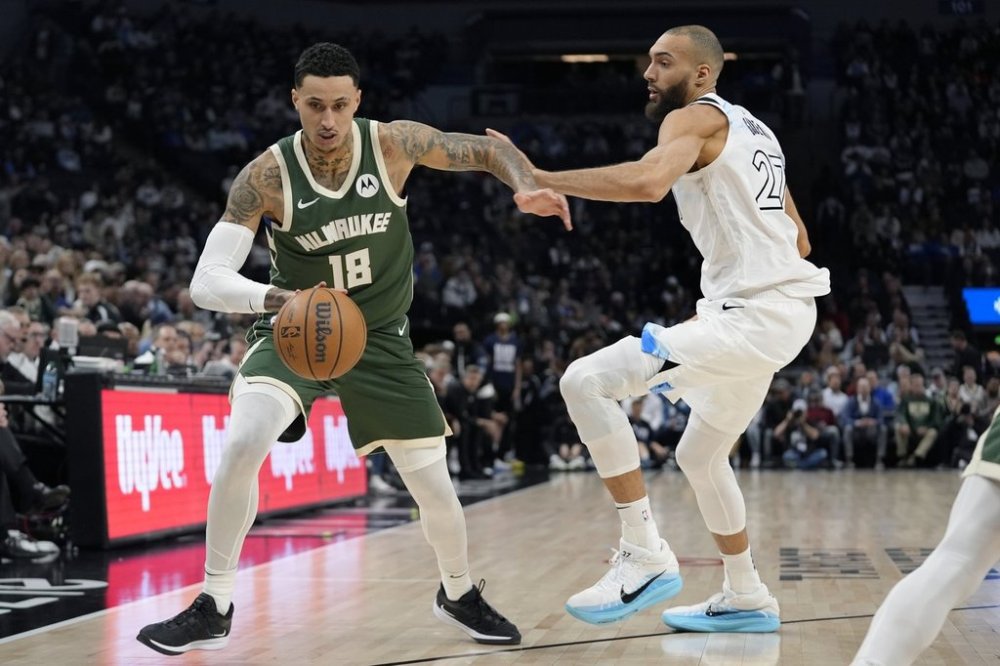 Milwaukee Bucks forward Kyle Kuzma (18) works toward the basket as Minnesota Timberwolves center Rudy Gobert (27) defends during the first half of an NBA basketball game, Wednesday, Feb. 12, 2025, in Minneapolis. (AP Photo/Abbie Parr)