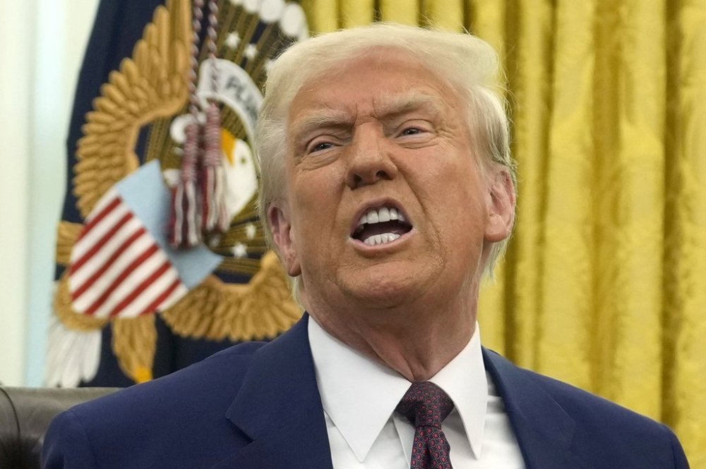 U.S. President Donald Trump speaks to reporters after signing an executive order in the Oval Office of the White House, in Washington, Thursday, Feb. 13, 2025. THE CANADIAN PRESS/AP-Ben Curtis