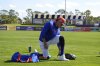 New York Mets outfielder Juan Soto changes his shoes during a spring training baseball practice Monday, Feb. 17, 2025, in Port St. Lucie, Fla. (AP Photo/Jeff Roberson)