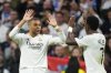 Real Madrid's Vinicius Junior, right, celebrates with Kylian Mbappe after scoring his side's second goal during the Spanish La Liga soccer match between Real Madrid and Girona at the Santiago Bernabeu stadium in Madrid, Spain, Sunday, Feb. 23, 2025. (AP Photo/Manu Fernandez)