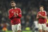 Manchester United's Bruno Fernandes applauds the crowd after the English Premier League soccer match between Tottenham Hotspur and Manchester United in London, Sunday, Feb. 16, 2025. (AP Photo/Ian Walton)