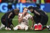 Bayern's Harry Kane receives medical attention during the German Bundesliga soccer match between Bayer Leverkusen and FC Bayern Munich in Leverkusen, Germany, Saturday, Feb. 15, 2025. (Marius Becker/dpa via AP)