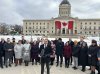 Premier Wab Kinew and members of his NDP caucus stand outside the legislative building for a press conference in Winnipeg on Tuesday, March 4, 2025. Politicians are returning to the Manitoba legislative chamber today amid the economic fallout from U.S. tariffs and ongoing challenges in provincial health care. THE CANADIAN PRESS/Steve Lambert