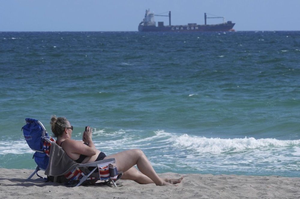 A beachgoer enjoys the warm weather Wednesday, Feb. 12, 2025, in Fort Lauderdale, Fla. (AP Photo/Marta Lavandier)