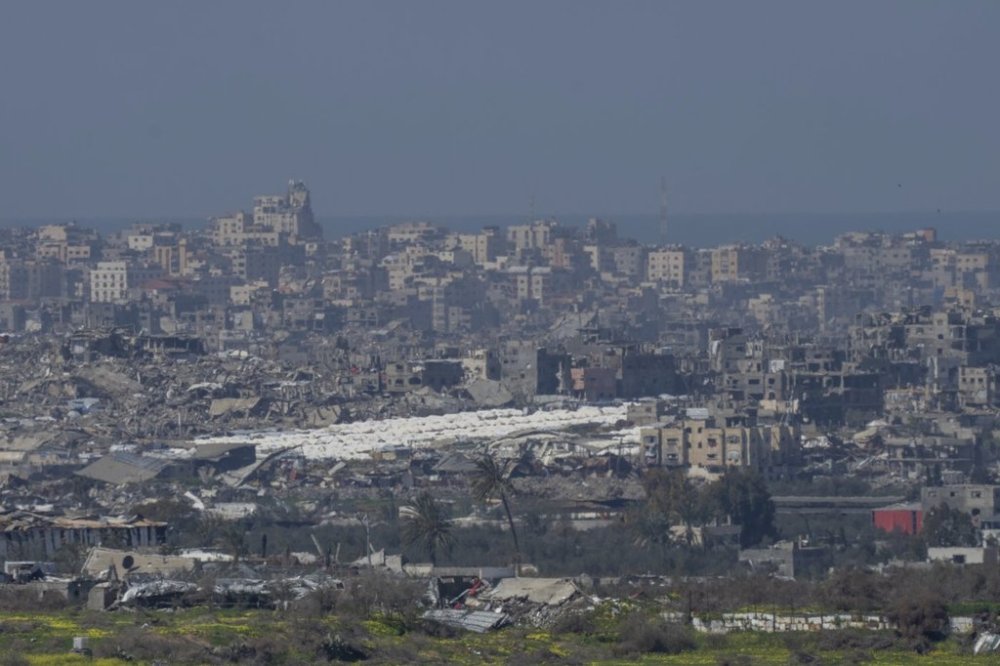 Tents are seen among the destroyed buildings in the Gaza Strip as seen from southern Israel, Tuesday, Feb. 25, 2025. (AP Photo/Ohad Zwigenberg)