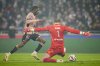 Lyon's goalkeeper Lucas Perri, right, makes a save in front of PSG's Ousmane Dembele during the French League One soccer match between Lyon and Paris Saint-Germain at the Groupama stadium, outside Lyon, France, Sunday, Feb. 23, 2025. (AP Photo/Laurent Cipriani)