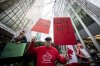 A demonstrator holds up signs during a protest outside of the U.S embassy in Vancouver B.C., on Tuesday, March 4, 2025. THE CANADIAN PRESS/Ethan Cairns