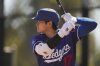 Los Angeles Dodgers two-way player Shohei Ohtani works out during a spring training baseball practice, Wednesday, Feb. 26, 2025, in Phoenix. (AP Photo/Ashley Landis)