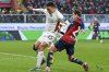 Genoa's Fabio Miretti, right, and Venezia's Joel Schingtienne, left, challenge for the ball during the Serie A soccer match between CFC Genoa 1893 and FC Venezia in Genoa, Italy, Monday, Feb. 17, 2025. (Tano Pecoraro/LaPresse via AP)