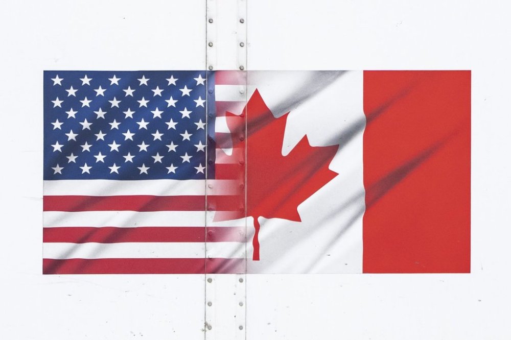 U.S. and Canada flags are seen on a transport truck trailer at the Pacific Highway Canada-U.S. border crossing in Surrey B.C., on Tuesday, March 4, 2025. THE CANADIAN PRESS/Ethan Cairns