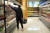 A shopper reaches for groceries in a small-format No Frills grocery store in Toronto, Thursday, May 30, 2024. THE CANADIAN PRESS/Chris Young