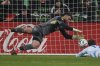 Sporting Kansas City goalkeeper John Pulskamp (1) dives to make a save during the second half of an MLS soccer match against the Austin FC in Austin, Texas, Saturday, Feb. 22, 2025. (AP Photo/Eric Gay)