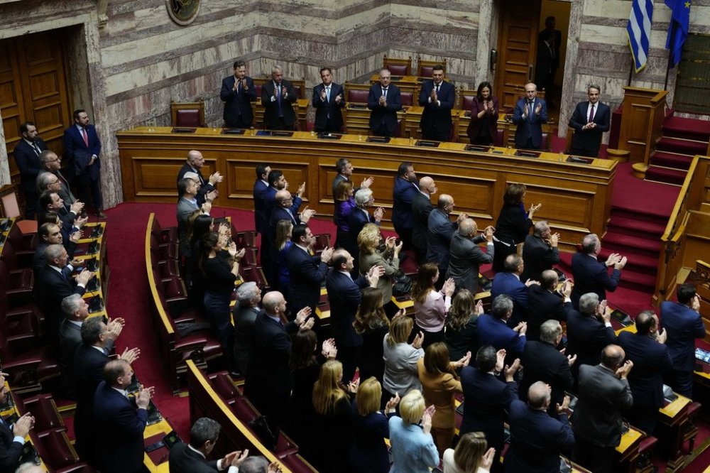 Lawmakers of the New Democracy's ruling party applaud after the election of former Parliament Speaker Constantine Tassoulas as Greece's new president at the Parliament, in Athens, Greece, Wednesday, Feb. 12, 2025. (AP Photo/Thanassis Stavrakis)