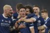 Bielefeld's goalscorer Marius Woerl, center, celebrates scoring his side's first goal of the game during the German soccer cup quarter final soccer match between Arminia Bielefeld and Werder Bremen, at Schueco Arena in Bielefeld, Germany, Tuesday, Feb. 25, 2025. (Friso Gentsch/dpa via AP)