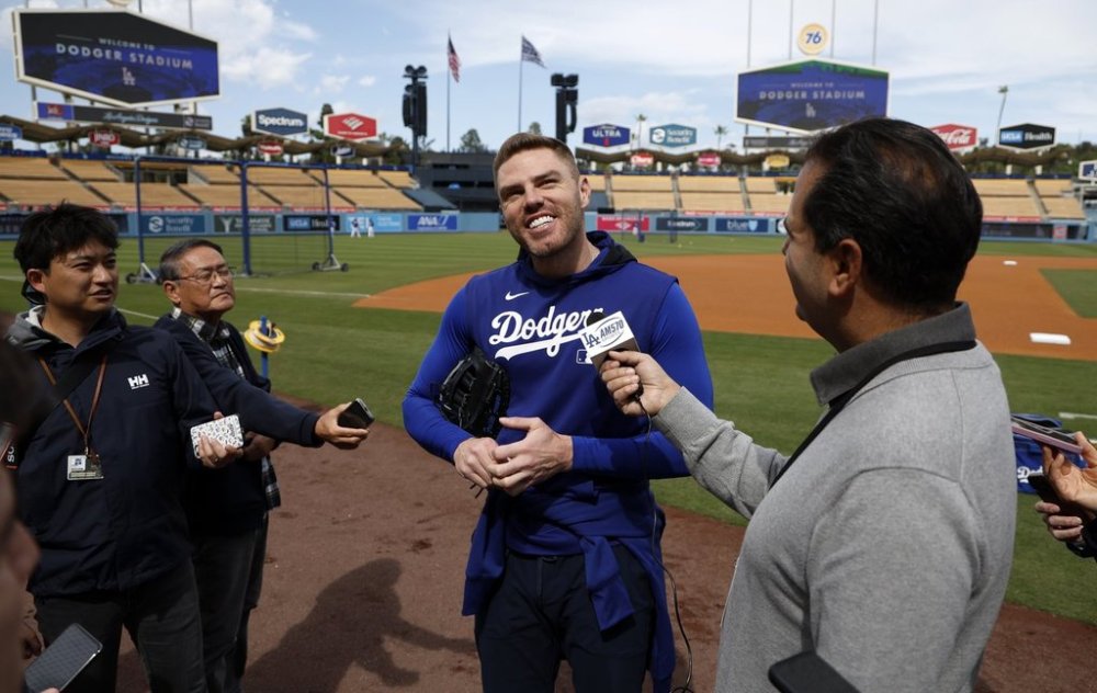 Los Angeles Dodgers' Freddie Freeman speaks to reporters during batting practice before a baseball game against the Atlanta Braves, Tuesday, April 1, 2025, in Los Angeles. (AP Photo/Kevork Djansezian)