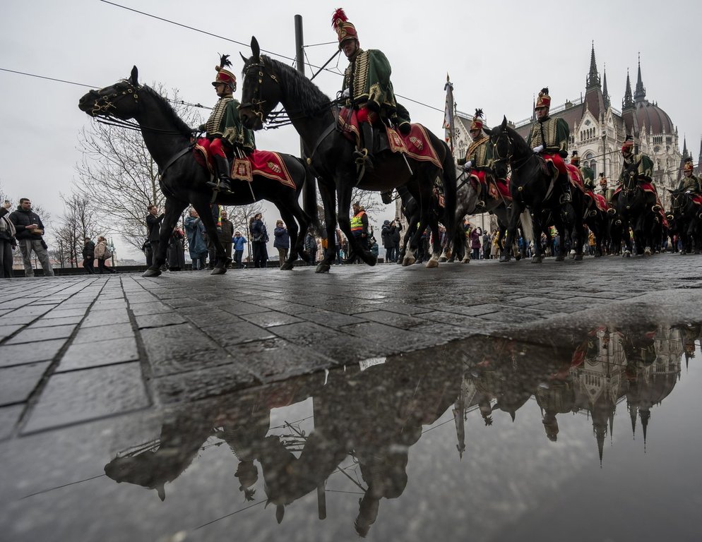 Mounted hussars ride during celebrations marking the 177th anniversary of the outbreak of the 1848 revolution and war of independence against Habsburg rule in Budapest, Hungary, Saturday, March 15, 2025. (Zoltan Balogh/MTI via AP)