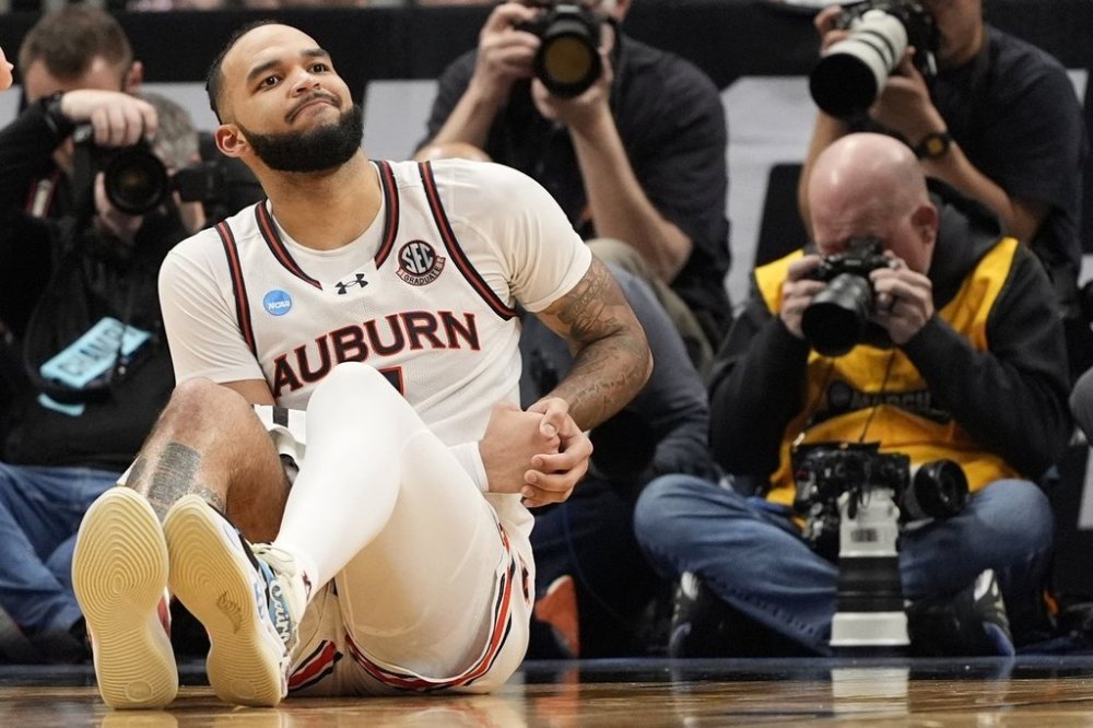 Auburn forward Johni Broome (4) sits on the court against Michigan State during the second half in the Elite Eight of the NCAA college basketball tournament, Sunday, March 30, 2025, in Atlanta. (AP Photo/Brynn Anderson)