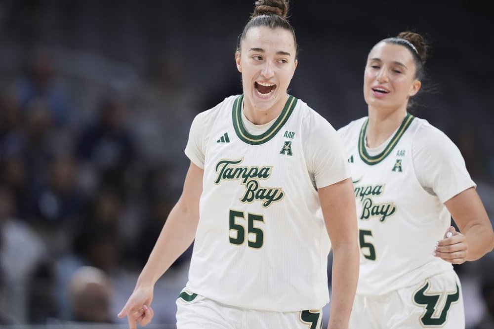 South Florida's Carla Brito (55) and Vittoria Blasigh (5) celebrate a three-pointer made by Brito in the first half of an NCAA college basketball game against Rice during the women's final of the American Athletic Conference tournament in Fort Worth, Texas, Wednesday, March 12, 2025. (AP Photo/Tony Gutierrez)