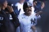 New York Yankees' Austin Wells celebrates his solo home run in the dugout during the first inning of an opening-day baseball game against the Milwaukee Brewers at Yankee Stadium, Thursday, March 27, 2025, in New York. (AP Photo/Seth Wenig)