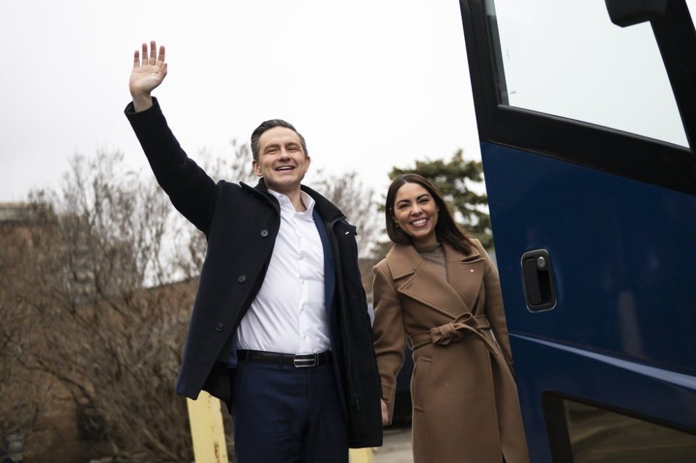 Federal Conservative leader Pierre Poilievre and wife Anaida Poilievre wave to supporters during a federal election campaign event in Richmond Hill, Ont., on Tuesday, March 25, 2025. THE CANADIAN PRESS/Christopher Katsarov