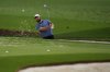 Scottie Scheffler chips on the practice range during a practice round at the Masters golf tournament, Monday, April 7, 2025, in Augusta, Ga. (AP Photo/Matt Slocum)