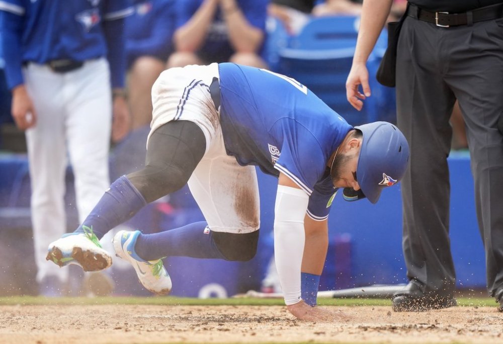 Toronto Blue Jays shortstop Bo Bichette slides safe at home plate to score a run against the New York Yankees during third inning Grapefruit League MLB baseball action in Dunedin Fla., Saturday, Feb. 22, 2025. THE CANADIAN PRESS/Nathan Denette