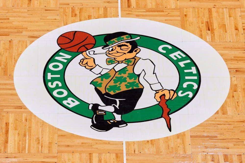 FILE - The Boston Celtics logo is seen at center court on the parquet floor before an NBA basketball game between the Boston Celtics and the Atlanta Hawks Sunday, Feb. 13, 2022, in Boston. (AP Photo/Winslow Townson, File)