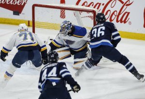 Winnipeg Jets' Morgan Barron (36) scores on St. Louis Blues goaltender Joel Hofer (30) during second period NHL action in Winnipeg on Monday, April 7, 2025. THE CANADIAN PRESS/John Woods