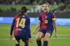 Barcelona's players Alexia Putellas, right, and Aitana Bonmati celebrate the opening goal during the Women's Champions League, quarter-final first leg, soccer match between VfL Wolfsburg and FC Barcelona in Wolfsburg, Germany, Wednesday, March 19, 2025. (Swen Pfoertner/dpa via AP)