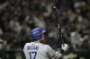 Los Angeles Dodgers' Shohei Ohtani waits on a pitch in the sixth inning of an MLB Japan Series baseball game against the Chicago Cubs in Tokyo, Japan, Tuesday, March 18, 2025. (AP Photo/Hiro Komae)