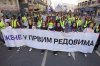 Women hold a banner reads: 