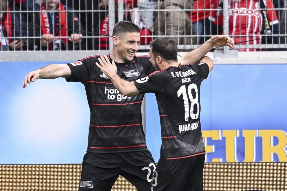 Berlin's Andrej Ilic, left, and Josip Juranovic celebrate after scoring their side's second goal during the German Bundesliga soccer match between SC Freiburg - 1. FC Union Berlin at The Europa-Park Stadion in Freiburg, Germany, Sunday, March 30, 2025. (Harry Langer/dpa via AP)