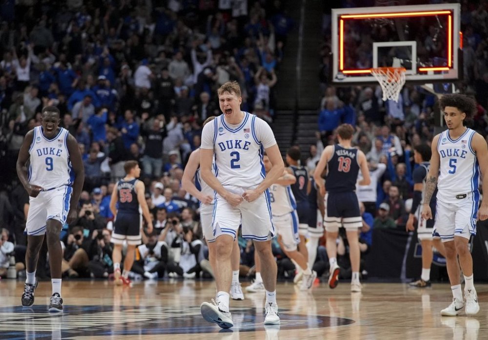 Duke forward Cooper Flagg (2) reacts after making a three point basket against Arizona to end the first half of a Sweet 16 round NCAA college basketball tournament game, Thursday, March 27, 2025, in Newark, N.J. (AP Photo/Frank Franklin II)