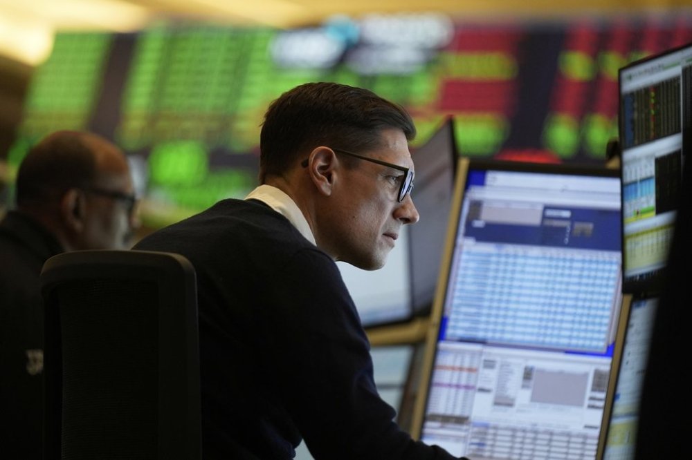 People work on the options floor at the New York Stock Exchange in New York, Wednesday, March 19, 2025. (AP Photo/Seth Wenig)