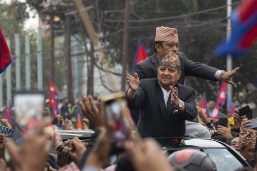 Former King Gyanendra Shah of Nepal waves upon his arrival at Tribhuvan International Airport in Kathmandu, Nepal, Sunday, March 9, 2025. (AP Photo/Niranjan Shrestha)