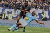 Napoli's Romelu Lukaku, right, is challenged by Venezia's Fali Cande during a Serie A soccer match between Venezia and Napoli at the Pier Luigi Penzo Stadium, in Venice, Italy, Sunday, March 16, 2025. (Paola Garbuio/LaPresse via AP)