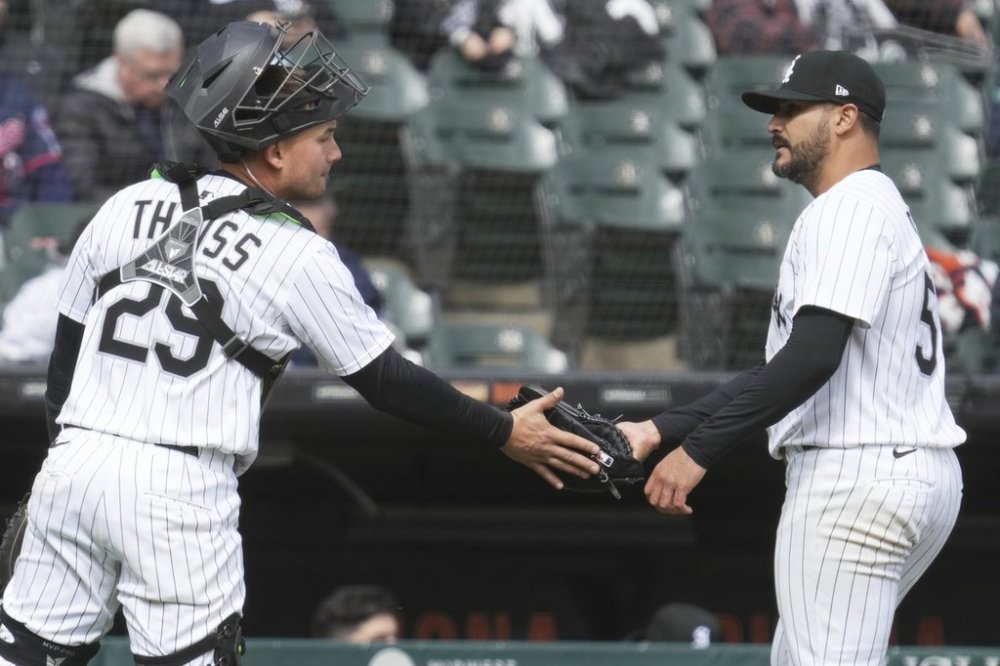 Chicago White Sox starting pitcher Martín Pérez, right, celebrates with catcher Matt Thaiss, left, as they go to the dugout after the fifth inning of a baseball game against the Minnesota Twins in Chicago, Monday, March 31, 2025. (AP Photo/Nam Y. Huh)