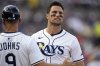 Tampa Bay Rays' Josh Lowe, right, winces in pain as he talks to first base coach Michael Johns (9) after his single during the fifth inning of a baseball game Friday, March 28, 2025, in Tampa, Fla. (AP Photo/Chris O'Meara)