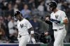 New York Yankees' Aaron Judge and Jazz Chisholm Jr. celebrate after Chisholm Jr. homered on a line drive to right field during the fourth inning of a baseball game against the Arizona Diamondbacks, Thursday, April 3, 2025, in New York. (AP Photo/Julia Demaree Nikhinson)