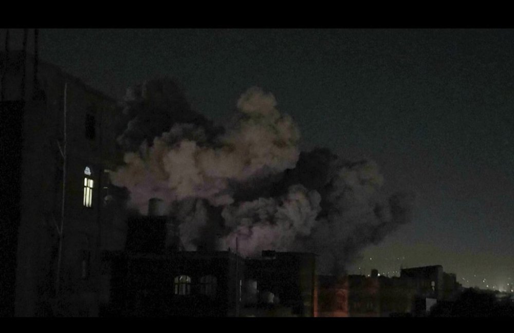 In this image made from video, smoke rises after a blast in Sanaa, Yemen, Friday, March 28, 2025. (AP Photo)