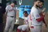 Boston Red Sox manager Alex Cora, left, talks to Rafael Devers, center, in the dugout after a baseball game against the Texas Rangers, Sunday, March 30, 2025, in Arlington, Texas. (AP Photo/LM Otero)