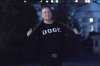 Elon Musk flashes his t-shirt that reads 