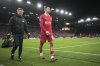 Liverpool's Trent Alexander-Arnold walks off injred during the Champions League round of 16 second leg soccer match between Liverpool and Paris Saint-Germain at Anfield in Liverpool, England, Tuesday, March 11, 2025. (AP Photo/Jon Super)