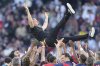 Paris Saint-Germain players throw PSG's head coach Luis Enrique in the air after they won the French League One soccer match between Paris Saint-Germain and Angers at Parc des Princes stadium in Paris, Saturday, April 5, 2025. (AP Photo/Michel Euler)