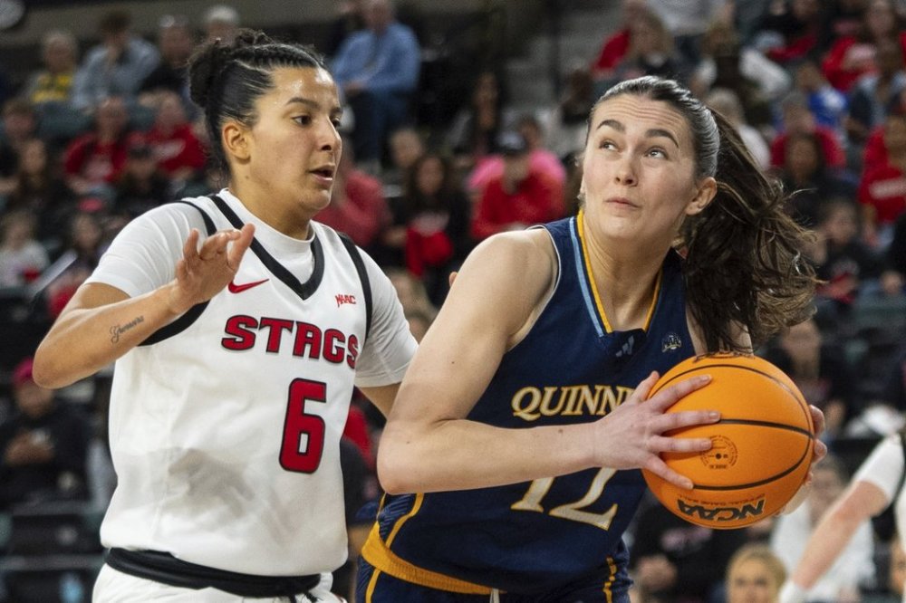 Quinnipiac's Ella O'Donnell, right, looks to shoot against Fairfield's Izabela Nicoletti Leite, left, during the first half of an NCAA college basketball game in the championship of the Metro Atlantic Athletic Conference tournament, Saturday, March 15, 2025, in Atlantic City, N.J. (AP Photo/Chris Szagola)